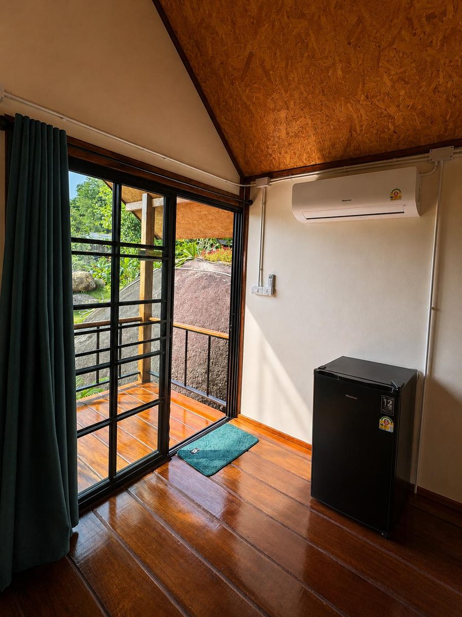 Room with fridge and glass doors to the terrace