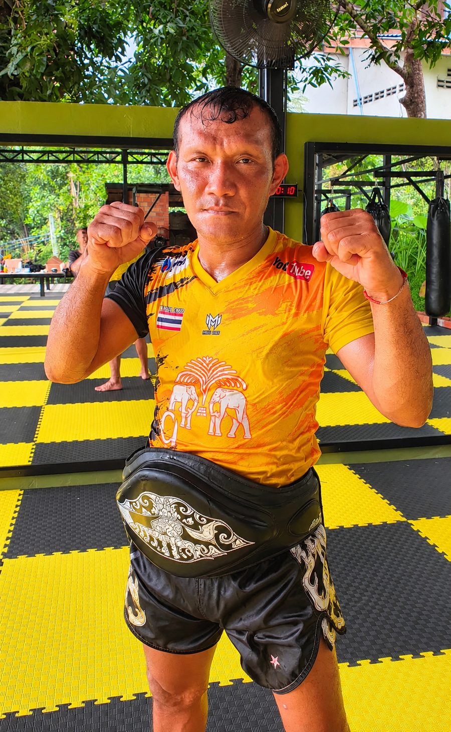 Kru Bao in training gear on the gym mats